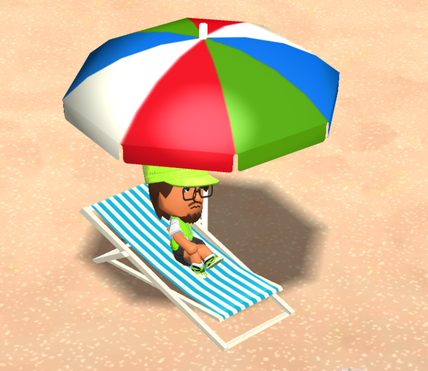 Vito sitting under an umbrella on the beach