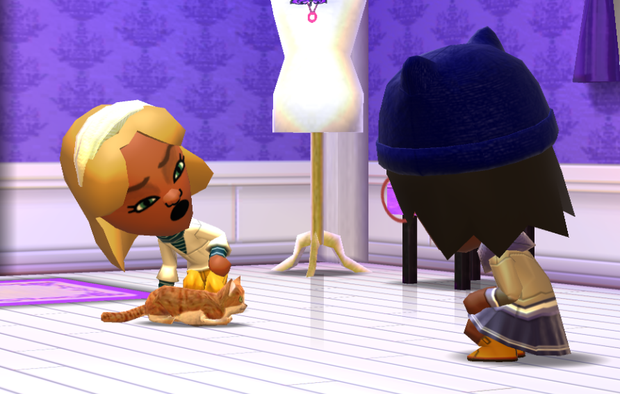 Jill talking to Lottie on the ground, touching the cat