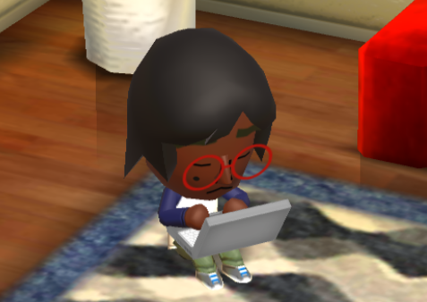 Lottie sitting on the floor using a laptop